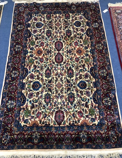 A Persian ivory ground rug 190 x 119cm